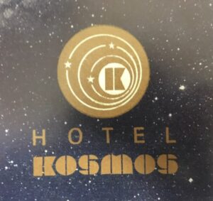 Photo of old "Hotel KOSMOS" logo from a menu with a galaxy in the background.